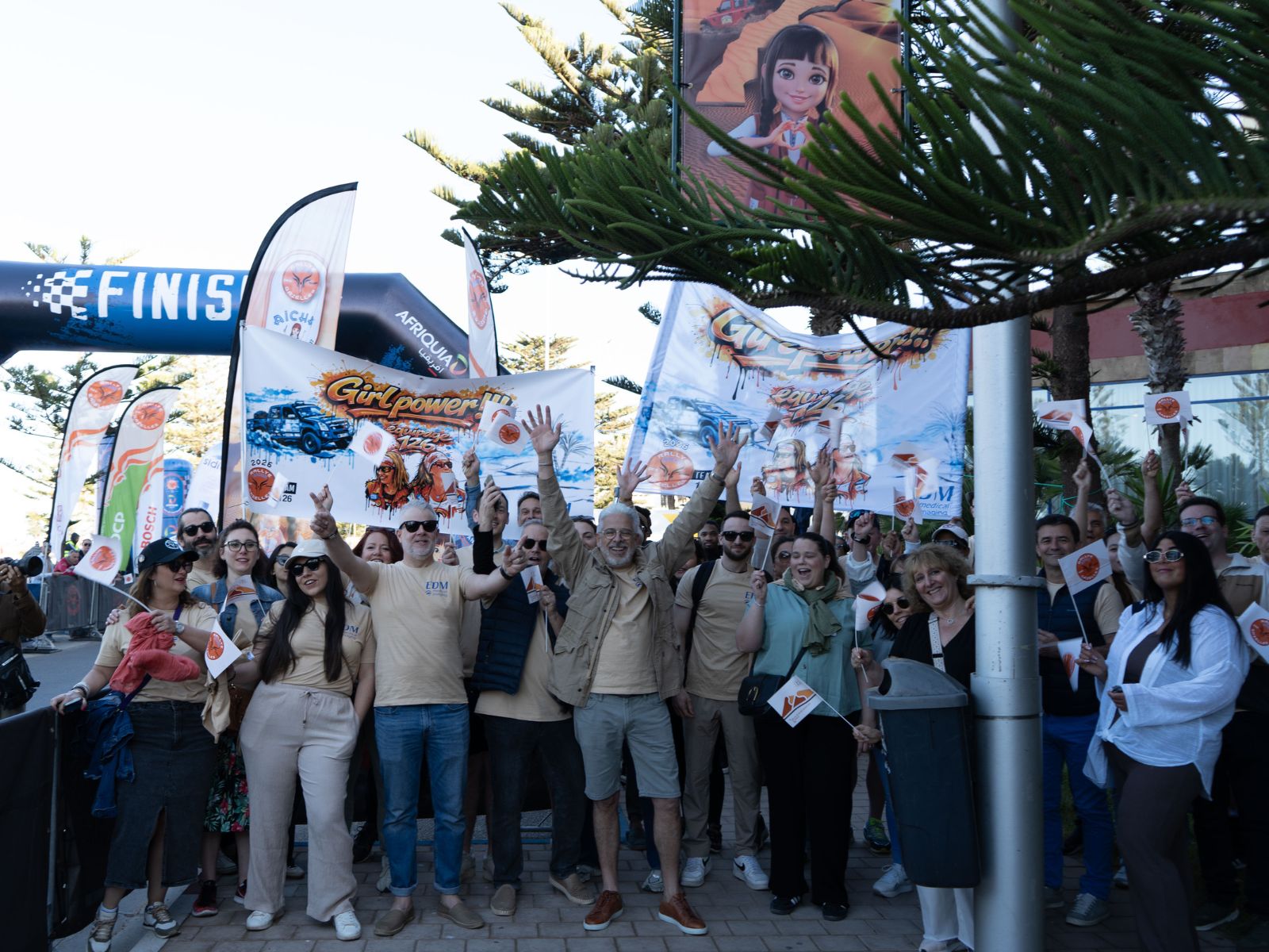 Les équipes EDM sur la ligne d'arrivée à Essaouira, drapeaux Girlpower déployés